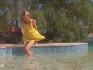 Pale blonde teen with attractive tits stripping by the pool